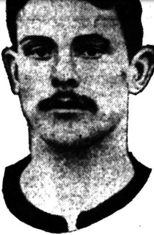 Newspaper portrait of a young man with a moustache in a dark-collared jersey